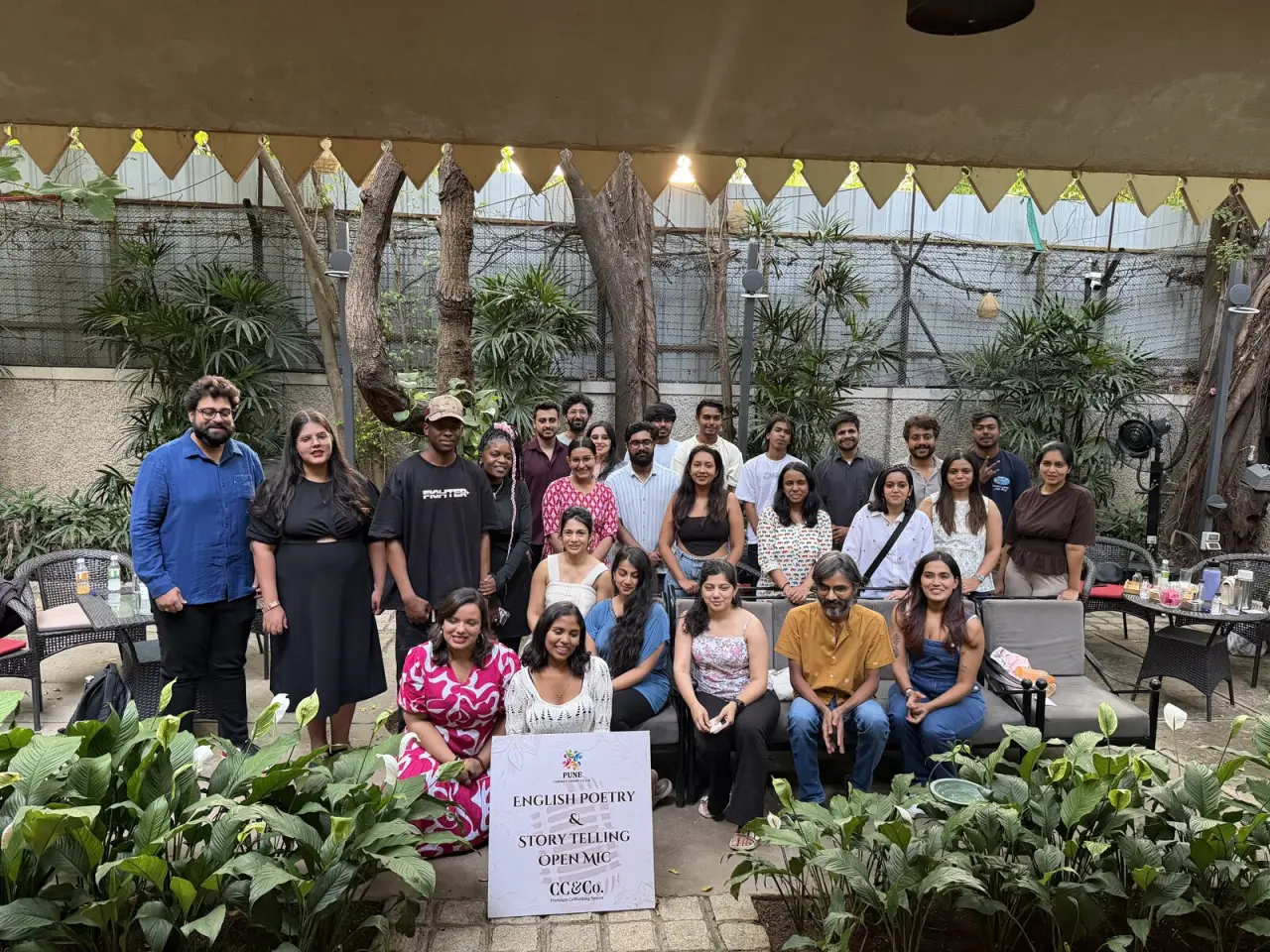 Warm-lit open mic stage with performer
